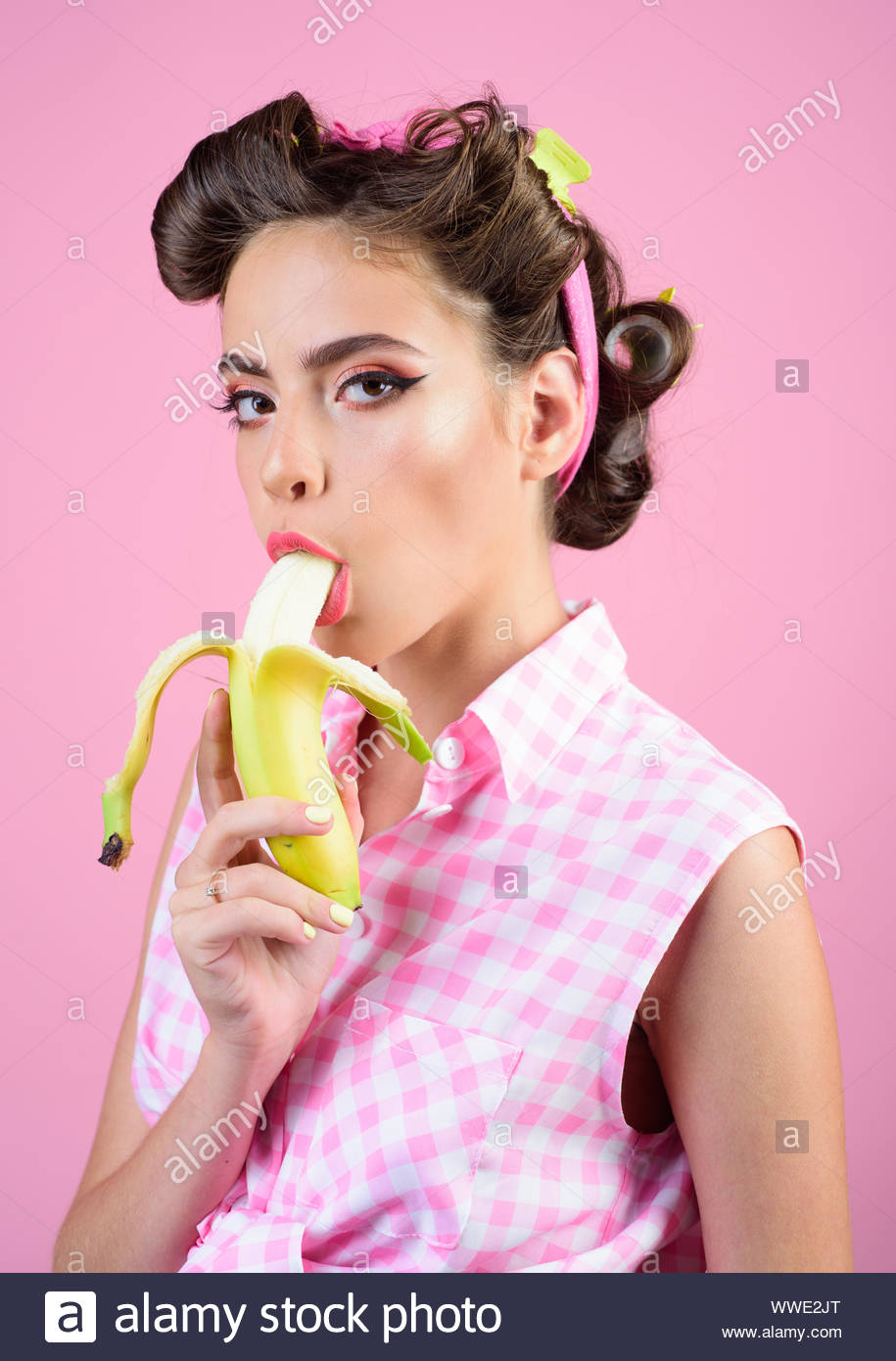 pretty-girl-in-vintage-style-pin-up-woman-with-trendy-makeup-pinup-girl-with-fashion-hair-banana-dieting-retro-woman-eating-banana-only-fresh-and-WWE2JT